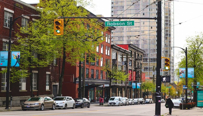 Robson Street in Vancouver with shopping, city life, and modern buildings